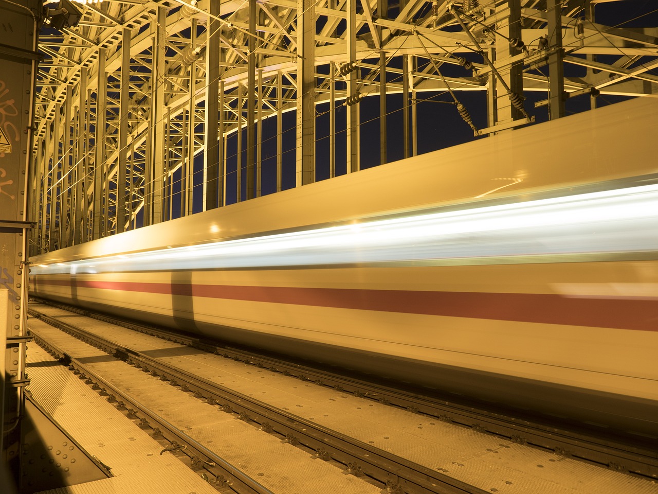 a train traveling over a bridge at night, a picture, by Jakob Gauermann, shutterstock, speed racer, fake detail, full frame image, stock photo