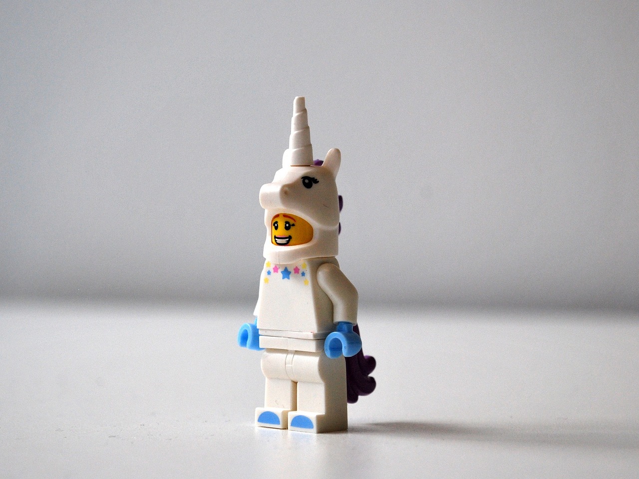 a lego unicorn standing on a white surface, unsplash, wears tiny spacesuit, mid 2 0's female, gelbooru, awkward