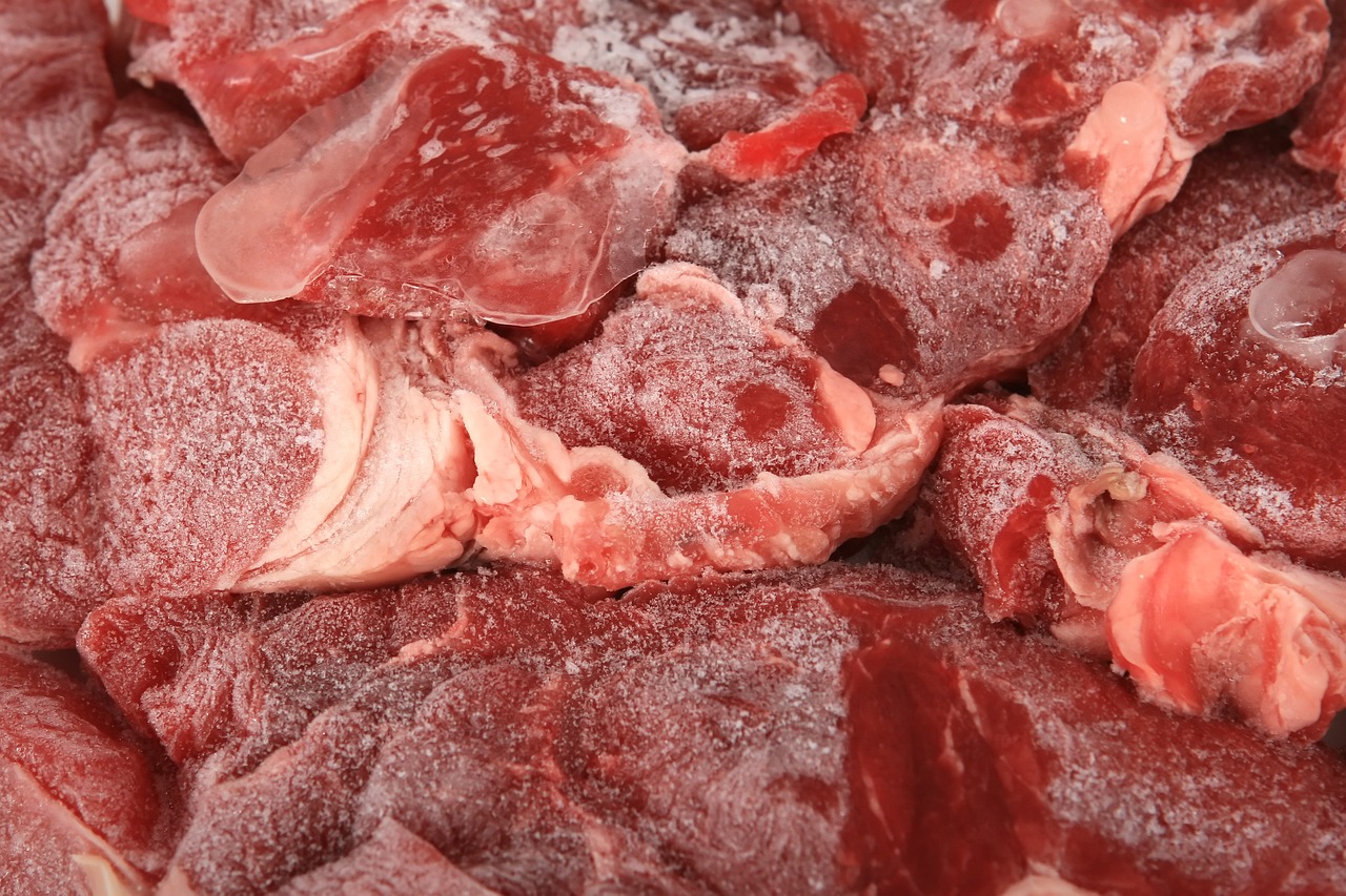 a pile of raw meat sitting on top of a counter, a picture, shutterstock, view from below, sleet, kidneys, half body photo