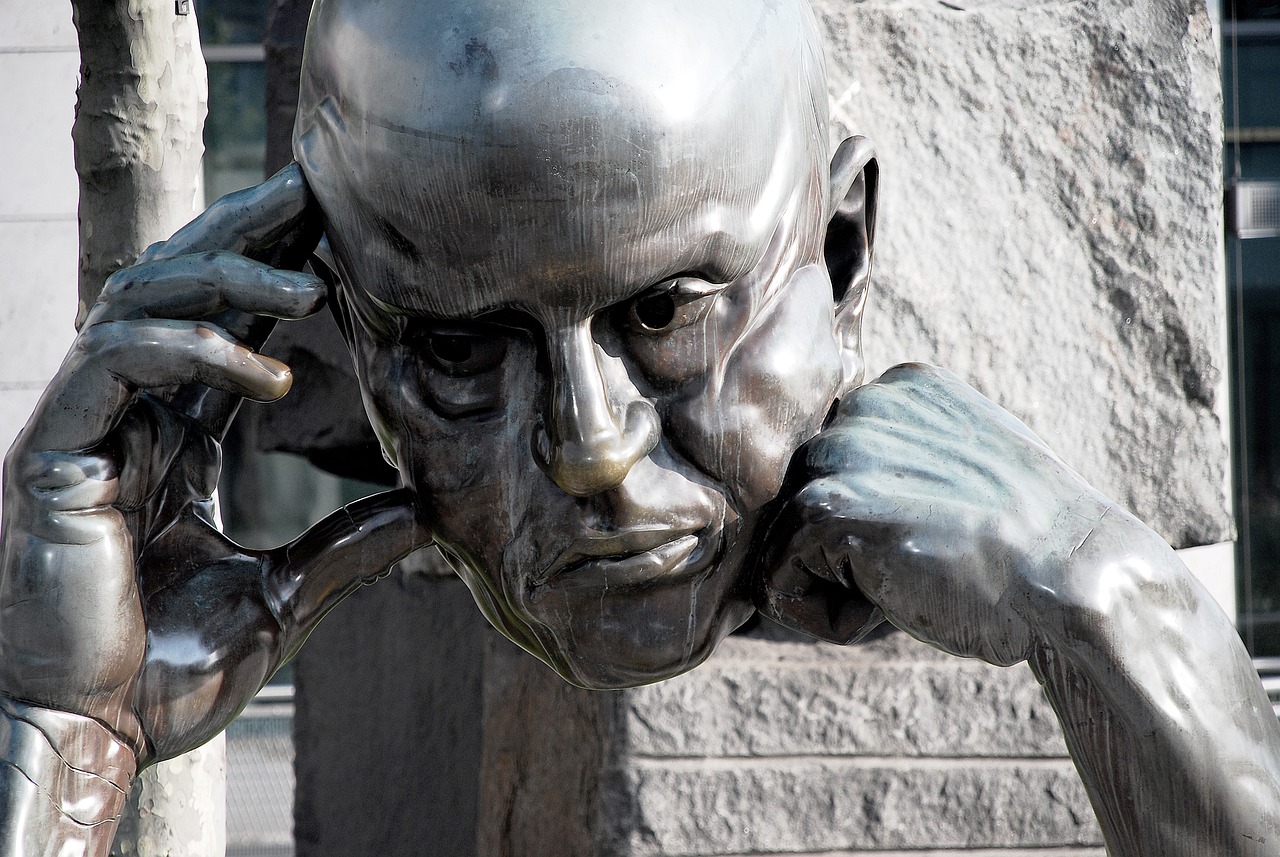 a statue of a man talking on a cell phone, a bronze sculpture, inspired by Sir Jacob Epstein, trending on pixabay, bald head and menacing look, hdr detail, chrome face symmetry, portrait of alan turing