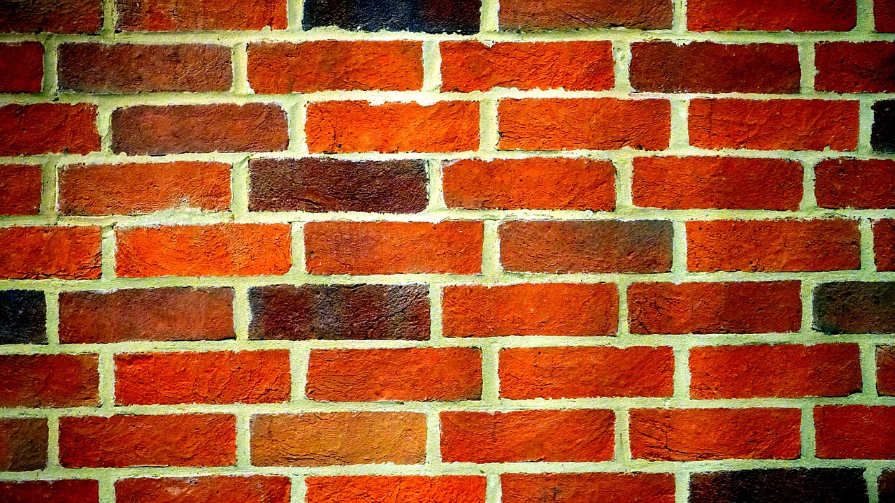 a fire hydrant in front of a brick wall, by Yi Jaegwan, minimalism, tessellation, closeup!!, red bricks, colors orange