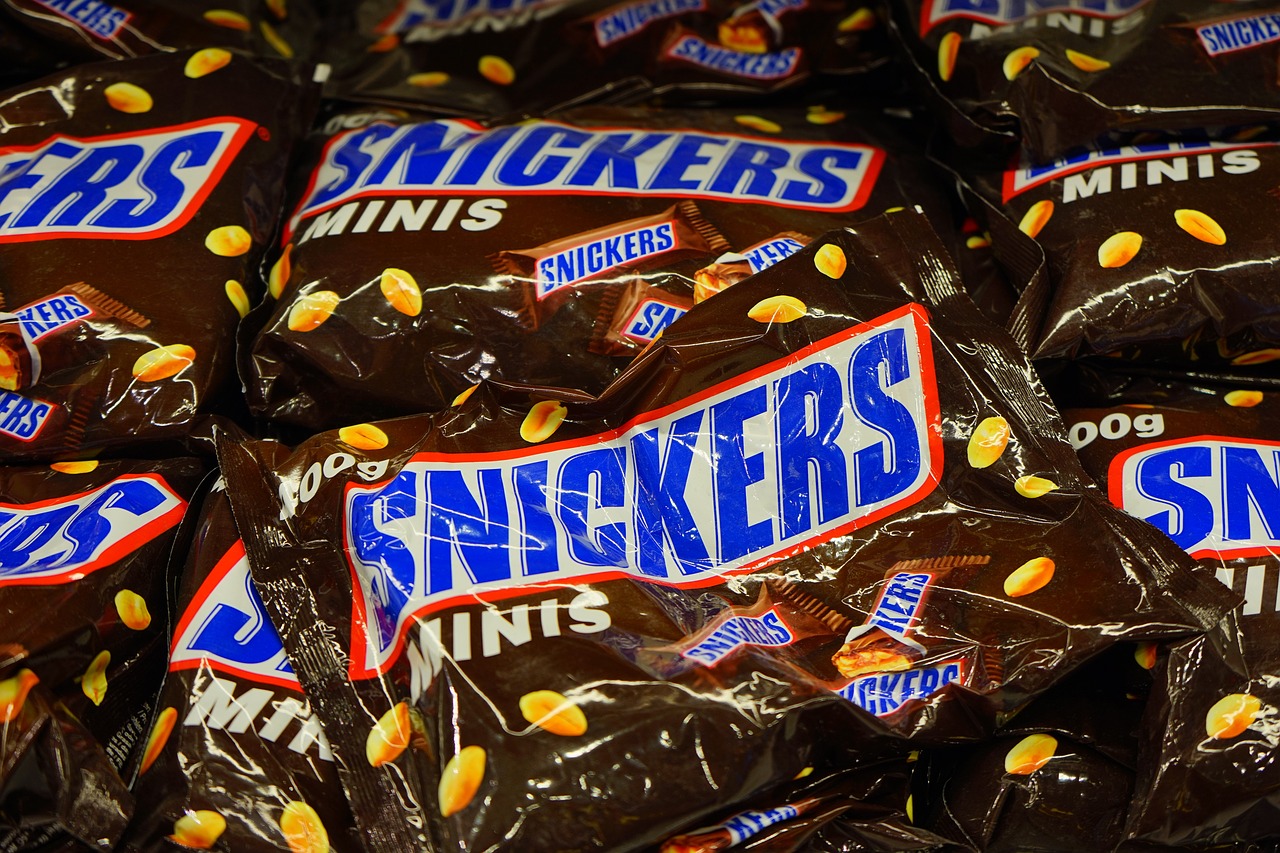 a pile of snickers candy sitting on top of each other, mingei, photorealism. trending on flickr, shot on nikon d 3 2 0 0, mittens, knick - knacks