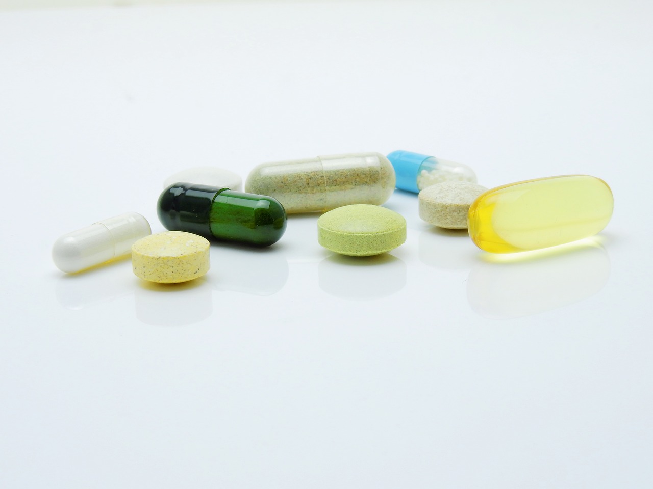 a bunch of pills sitting on top of a table, by Armin Hansen, antipodeans, clean white lab background, product introduction photo, multi - layer, a green