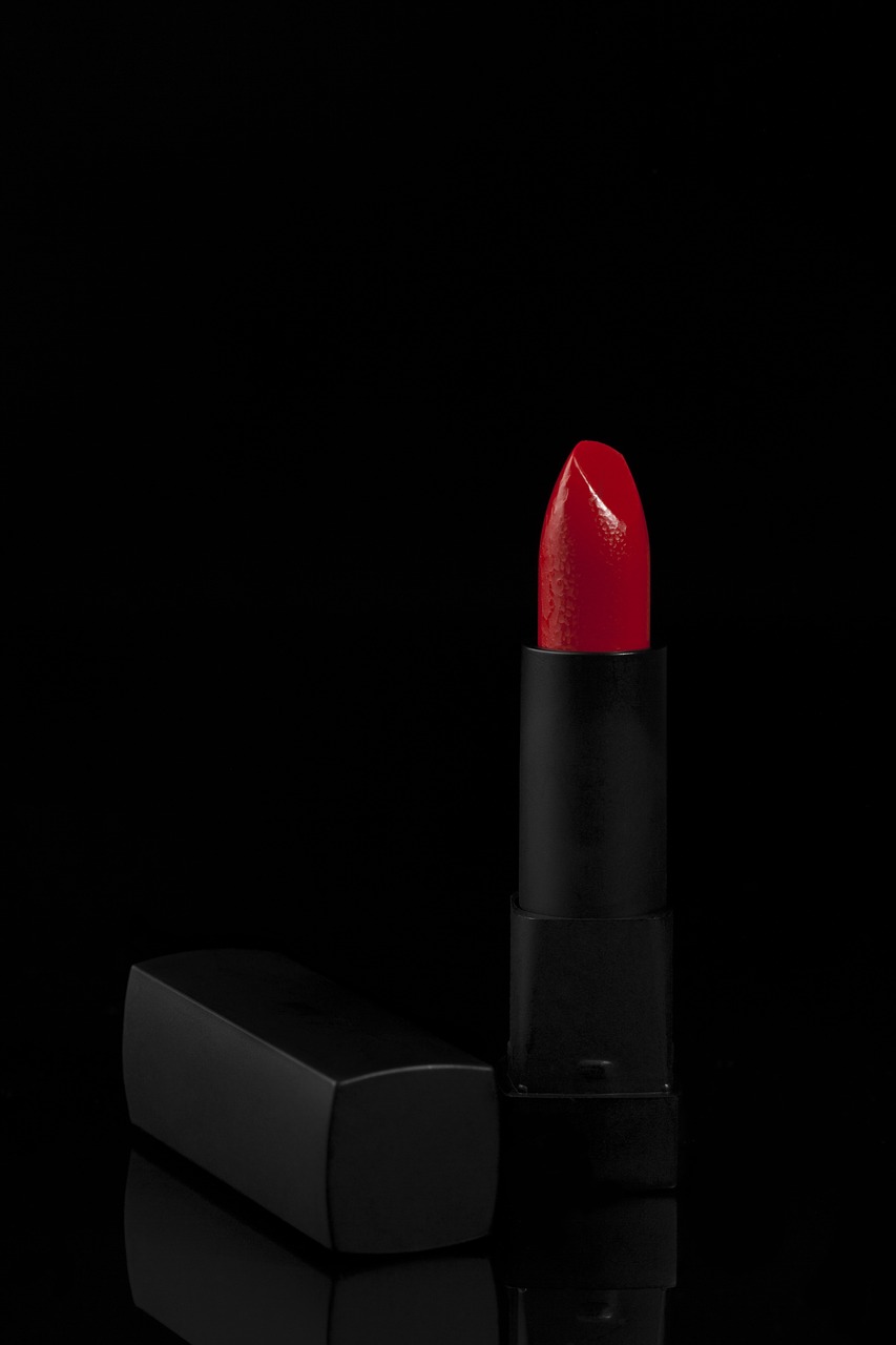a red lipstick sitting next to a black box, by Géza Dósa, high detail product photo, dark photo, 4 k product photo, modern very sharp photo