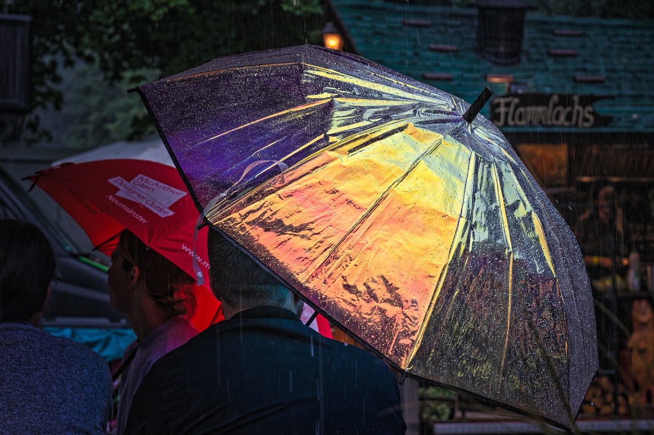 a group of people with umbrellas in the rain, a picture, by Jan Konůpek, pixabay, photorealism, refracted sunset lighting, colourful close up shot, shiny colorful, looking from side