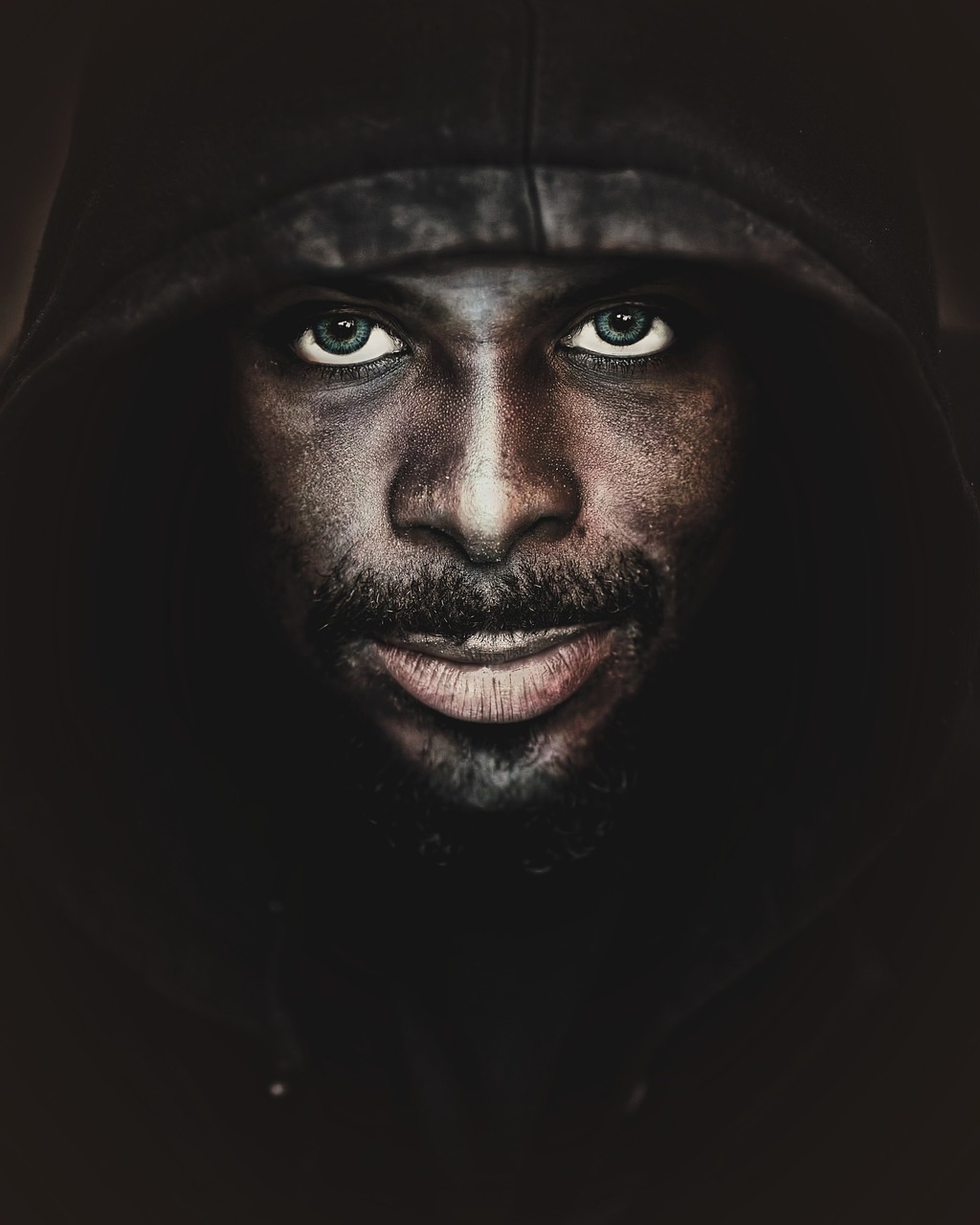 a close up of a person wearing a hoodie, a character portrait, inspired by Lee Jeffries, digital art, man is with black skin, fantasy character photo, fierce expression, full face and body portrait