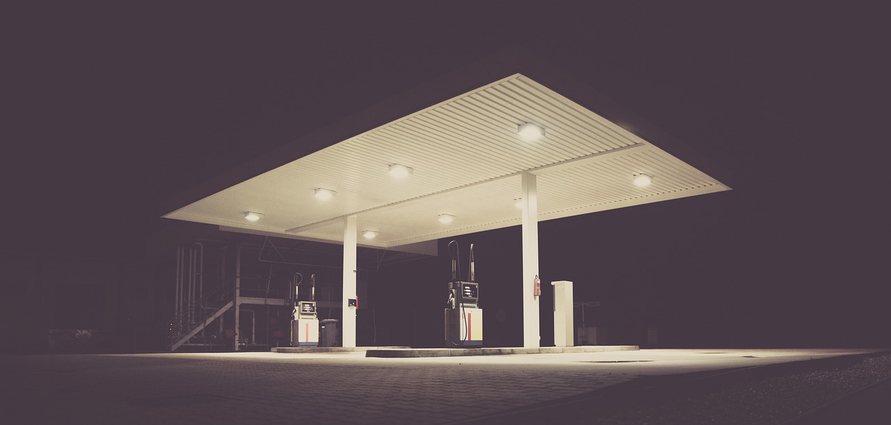 a black and white photo of a gas station at night, a picture, by Karl Buesgen, pexels, postminimalism, vintage color, clemens ascher, canopies, retro effect