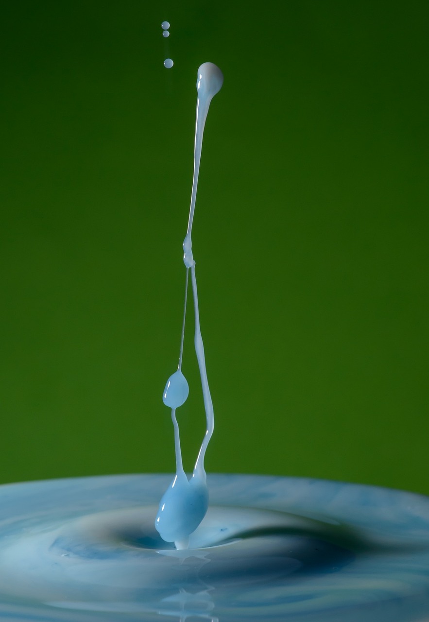 a close up of a water drop with a toothbrush in it, inspired by Lucio Fontana, spilled milk, green and blue tones, levitation, abstract claymation