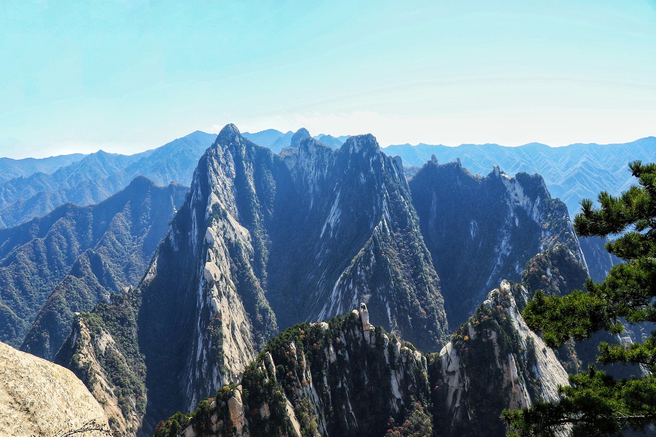 a group of people standing on top of a mountain, a picture, inspired by Li Keran, pexels, sōsaku hanga, ultra wide angle isometric view, baotou china, grand majestic mountains, seen from a distance