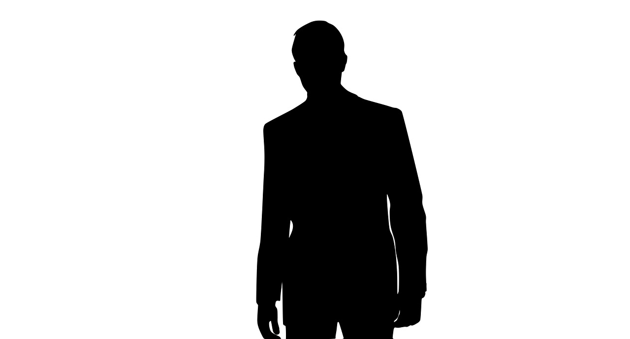 a silhouette of a man in a suit and tie, a stock photo, trending on pixabay, james bond, stock footage, clothed non - nude portrait, standing here