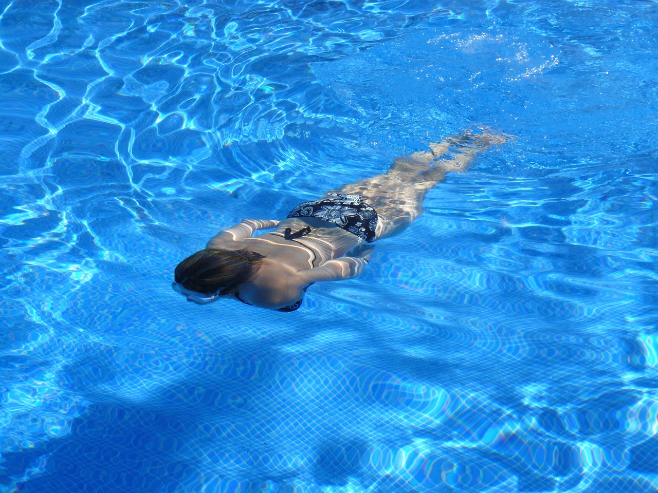 a person swimming in a pool on a sunny day, a photo, water to waist, shiny skin”, upsidedown, full length photo