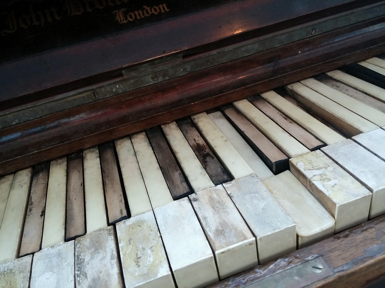 a close up of the keys of a piano, by Samuel Birmann, synthetism, broken tiles, london, in the middle of the day, bone and ivory