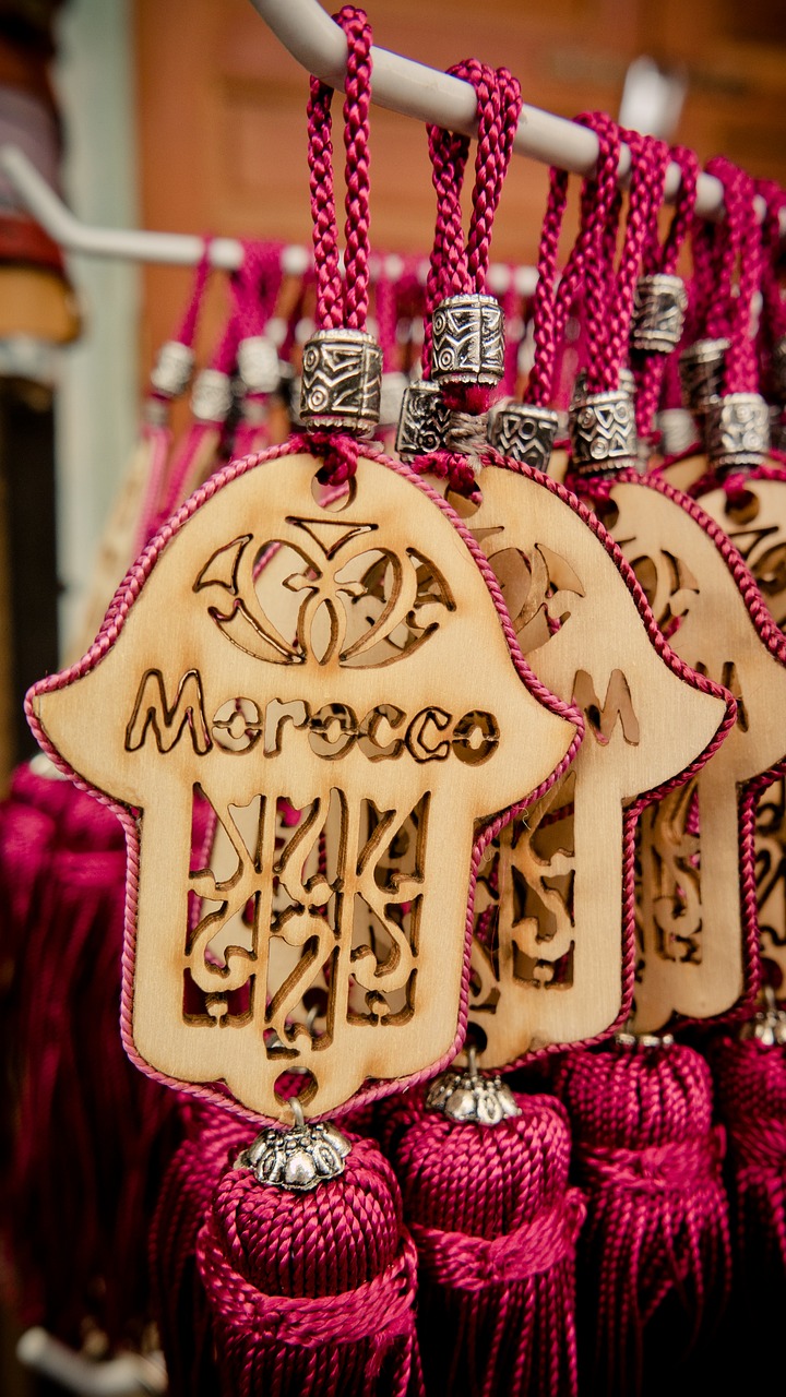 a close up of a bunch of tags on a rack, inspired by Alberto Morrocco, shutterstock, hurufiyya, hamsa hand, decorated polished wood, pink arches, tourist photo