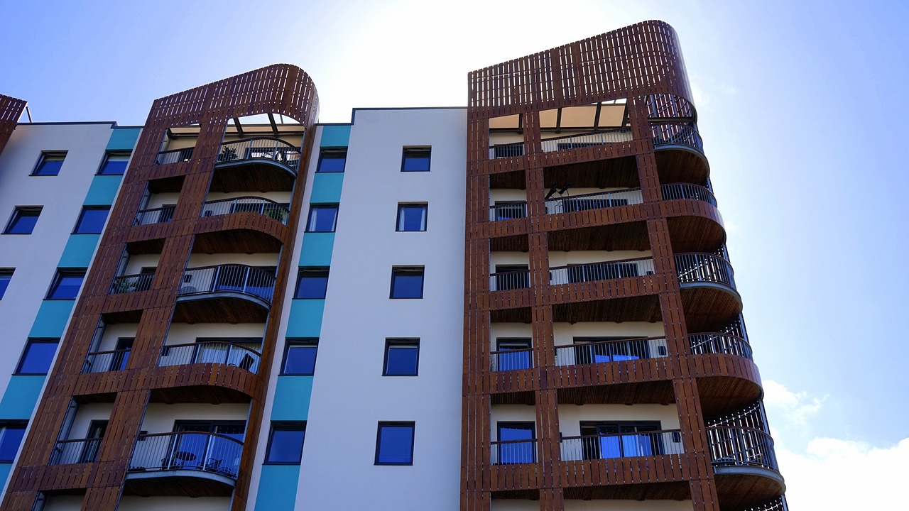 a tall building with balconies on top of it, a photo, by Lee Loughridge, shutterstock, a wooden, new modern, crenellated balconies, wide angle establishing shot