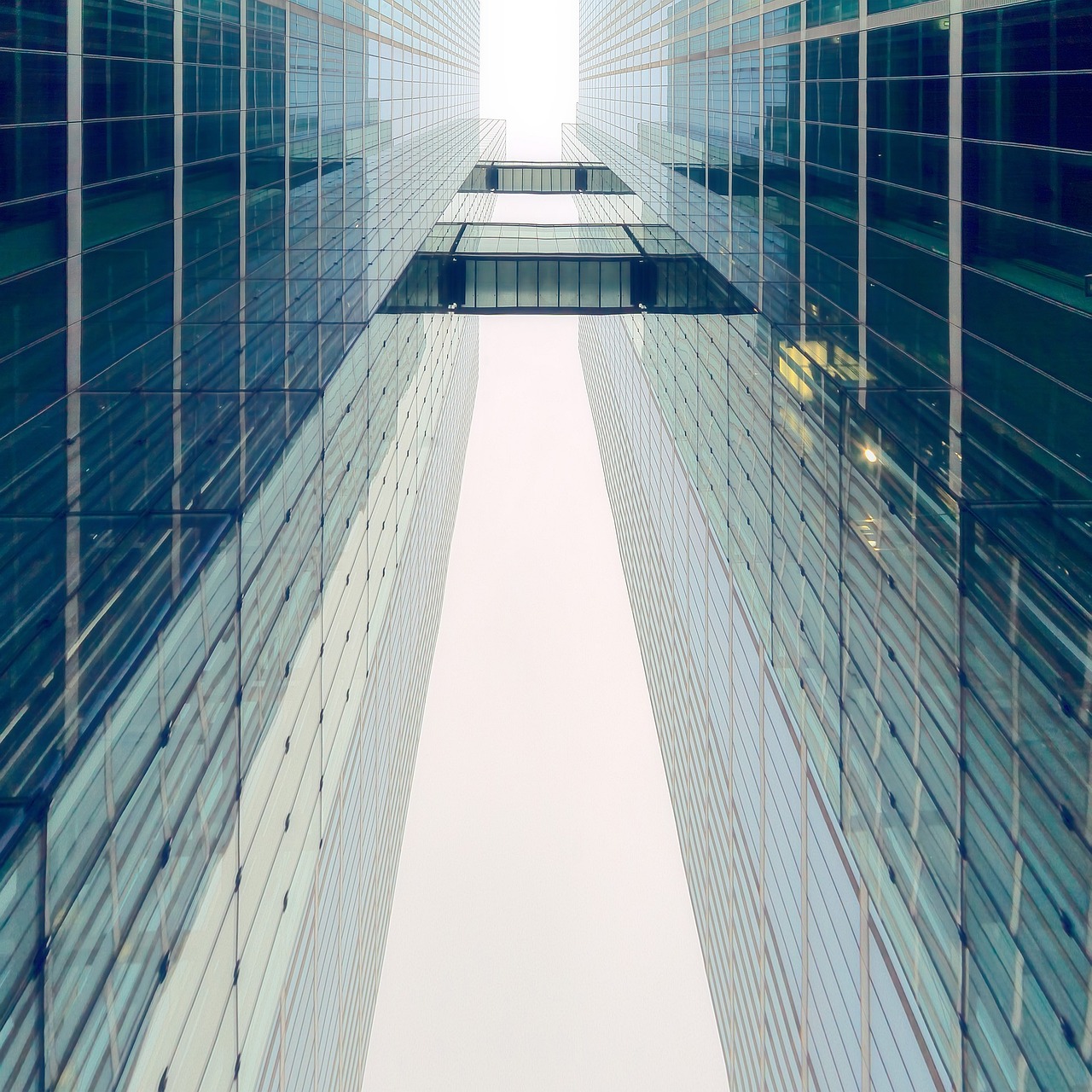 a couple of tall buildings next to each other, a screenshot, inspired by Richard Wilson, pexels contest winner, perfect symmetry, cinematic view from lower angle, high key detailed, tall entry