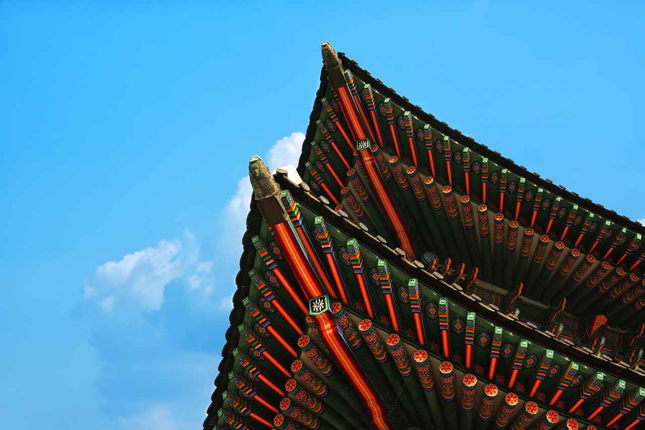 a bird is perched on the roof of a building, a picture, inspired by Kim Hong-do, shutterstock, cloisonnism, detail structure, ceremonial clouds, photo taken with canon 5d, high details photo