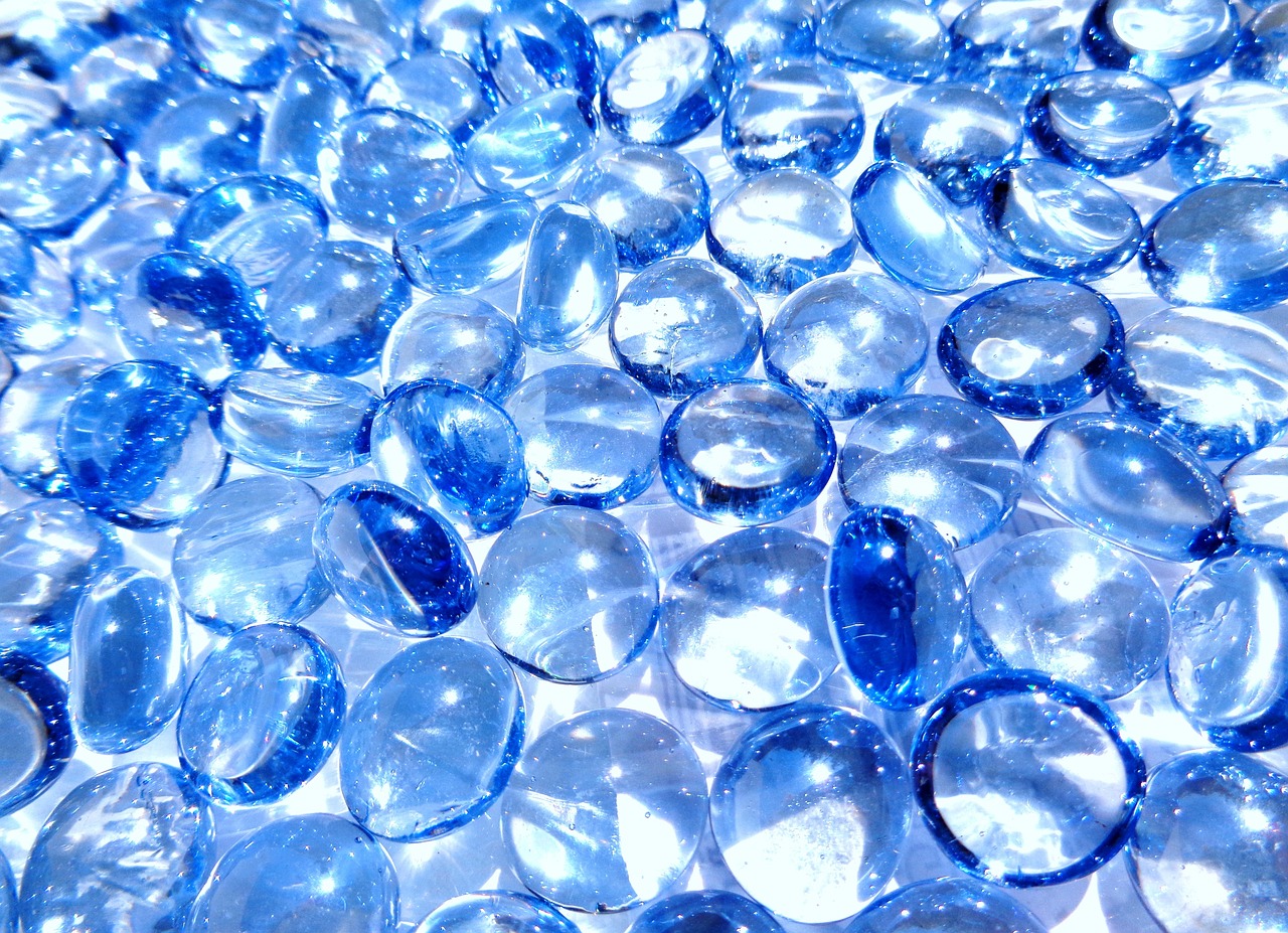 a pile of blue glass pebbles sitting on top of a table, pexels, “diamonds, jelly - like texture. photograph, photostock, transparent background