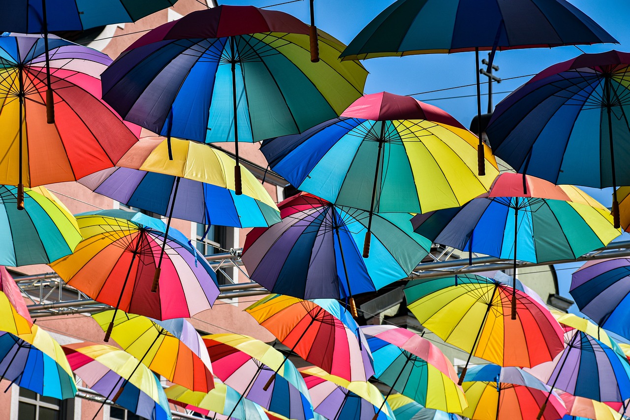 a bunch of colorful umbrellas hanging from the side of a building, a photo, by Dietmar Damerau, shutterstock, beautiful iphone wallpaper, canopies, full of colour 8-w 1024, multicolor