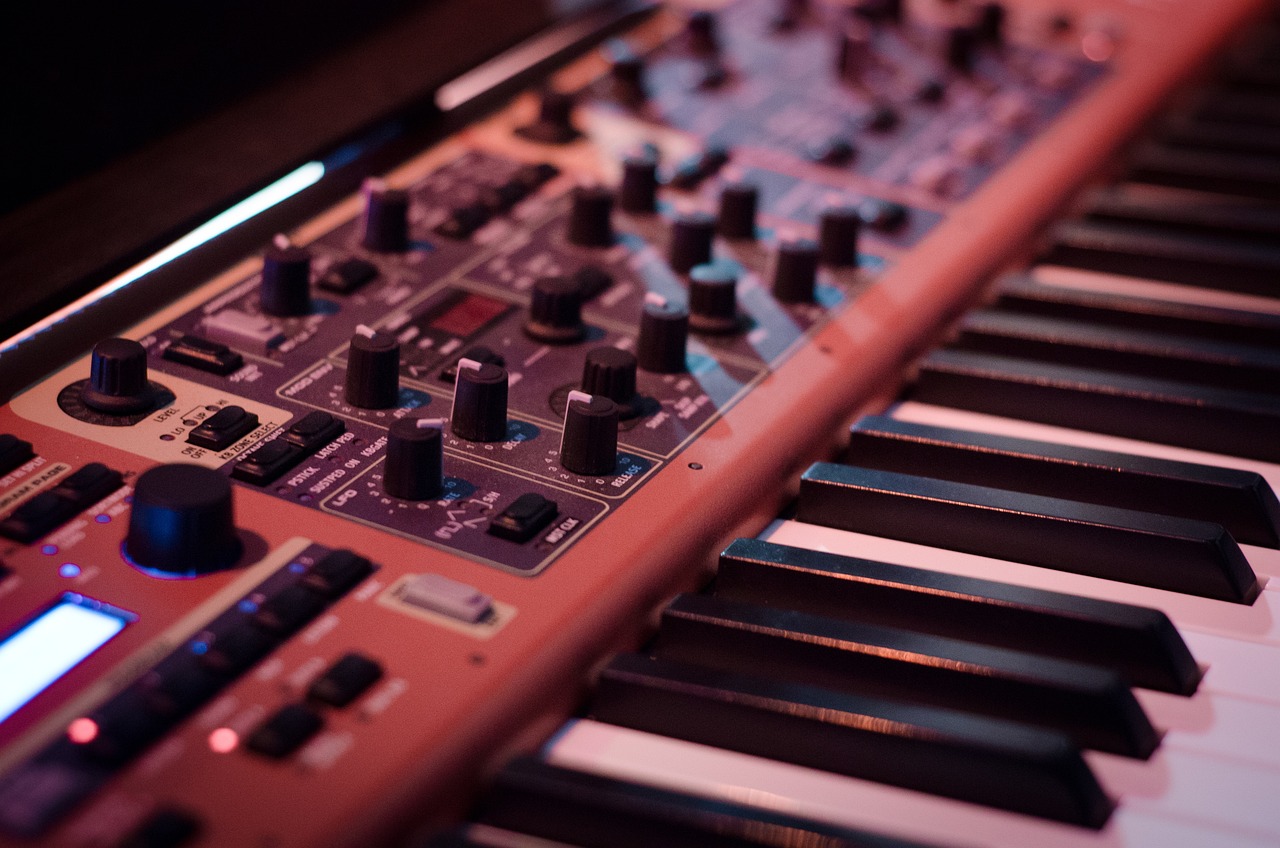 a close up of a keyboard with many knobs, by Andrei Kolkoutine, synthetism, pink studio lighting, nord, rack focus, an instrument