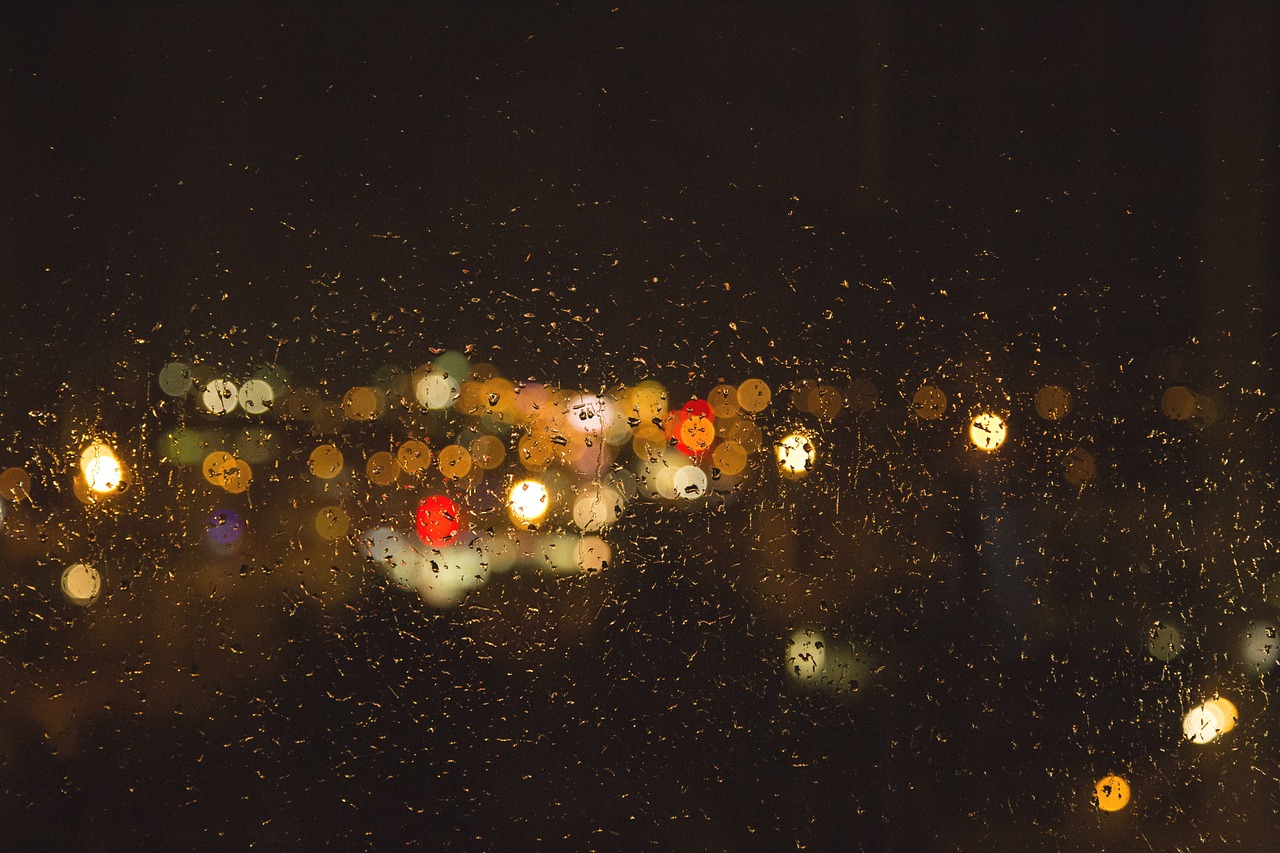 a view of a city through a rainy window, bokeh. brian spilner, koyaanisqatsi, summer night, aleksander rostov