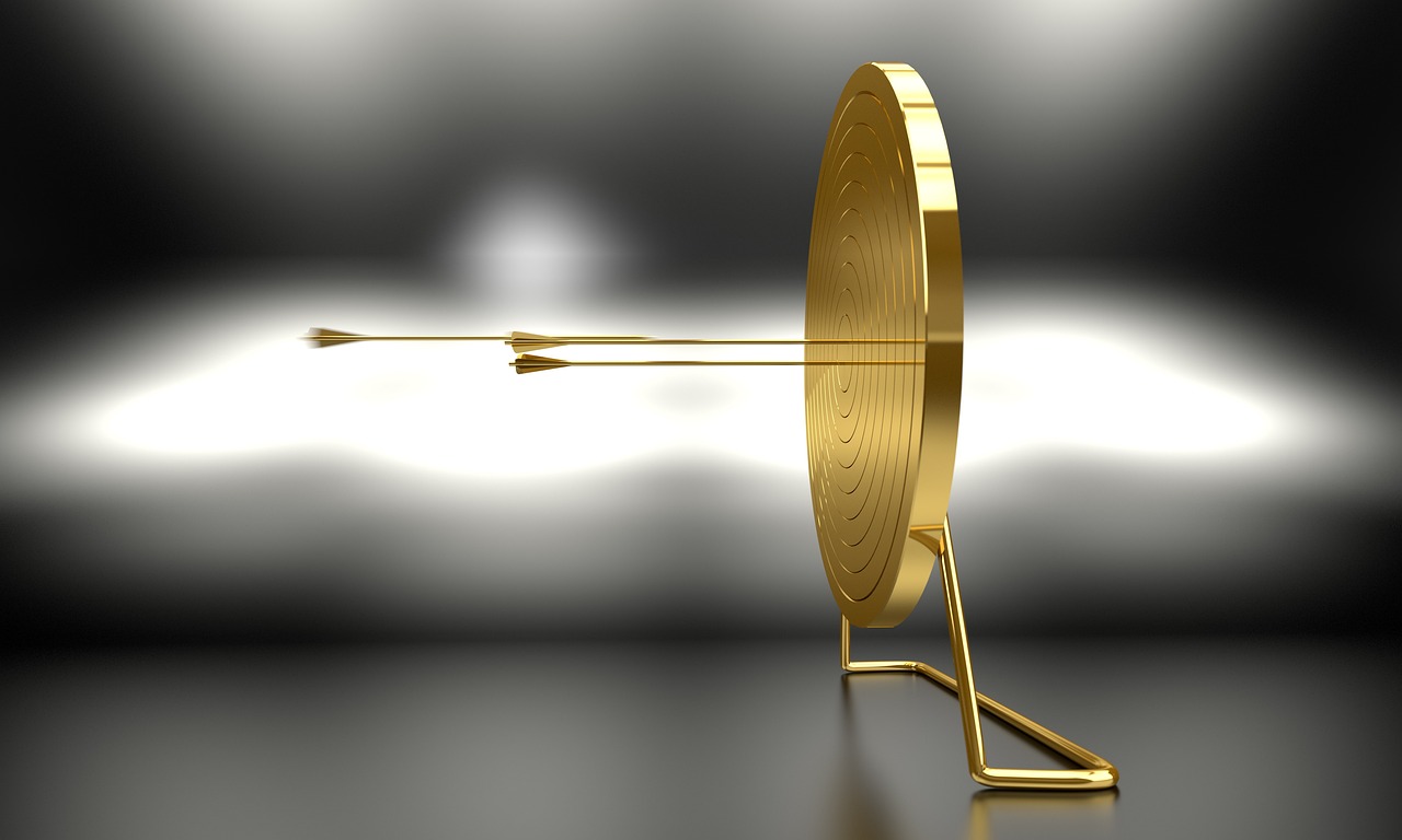 a gold target with an arrow sticking out of it, by Andrei Kolkoutine, trending on pixabay, kinetic art, award winning shot, coin, 14k gold wire, for hire 3d artist