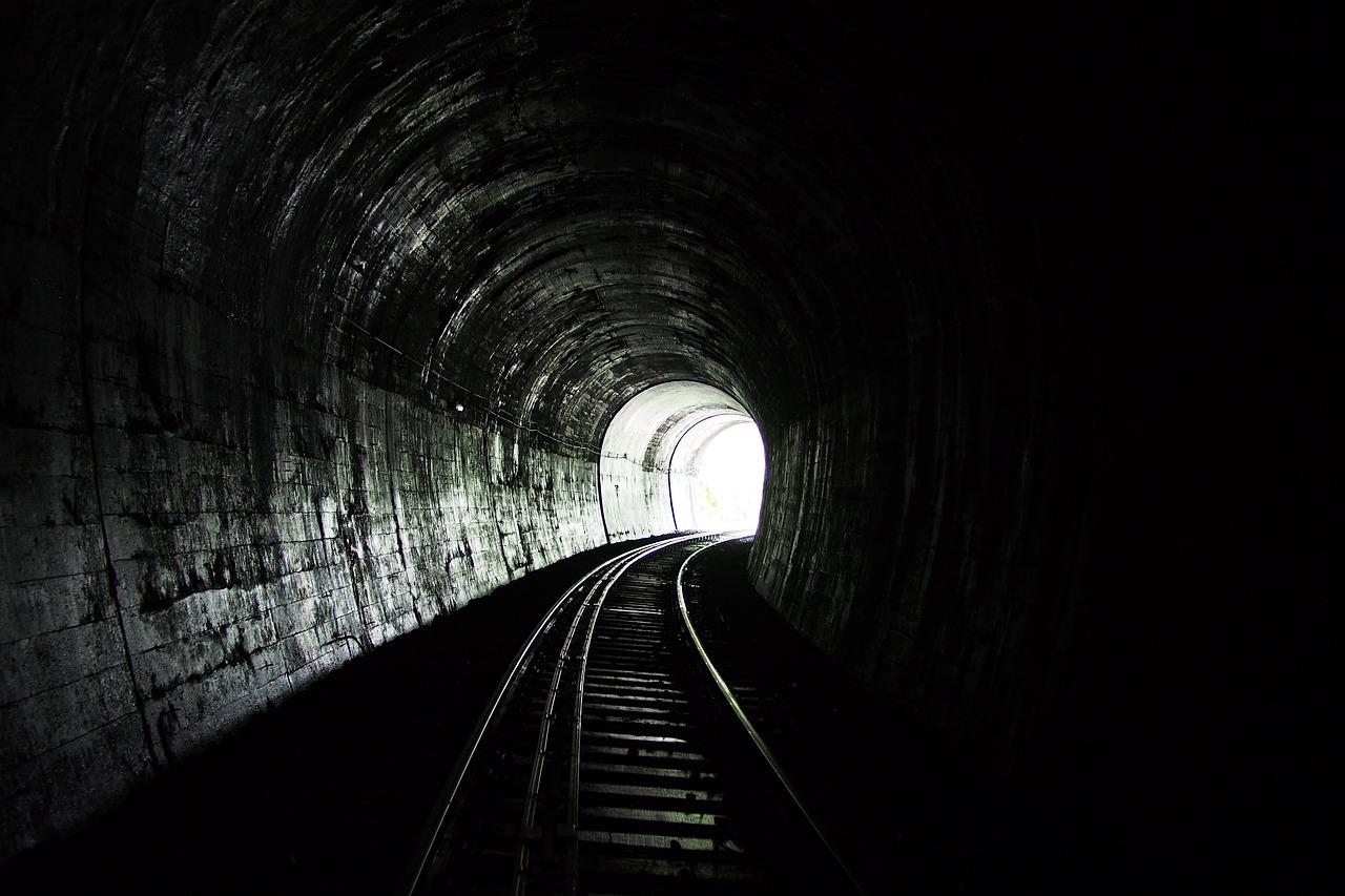 a dark tunnel with a train going through it, by Jon Coffelt, flickr, minimalism, portal to hell, unwind!, dark wallpaper, & a dark