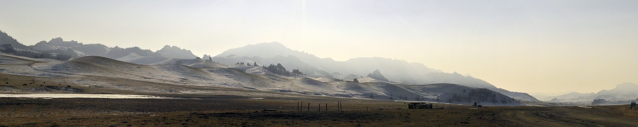 a truck driving down a dirt road with mountains in the background, a photo, baroque, winter mist around her, obsidian towers in the distance, kodak 4 0 0, steppe landscape