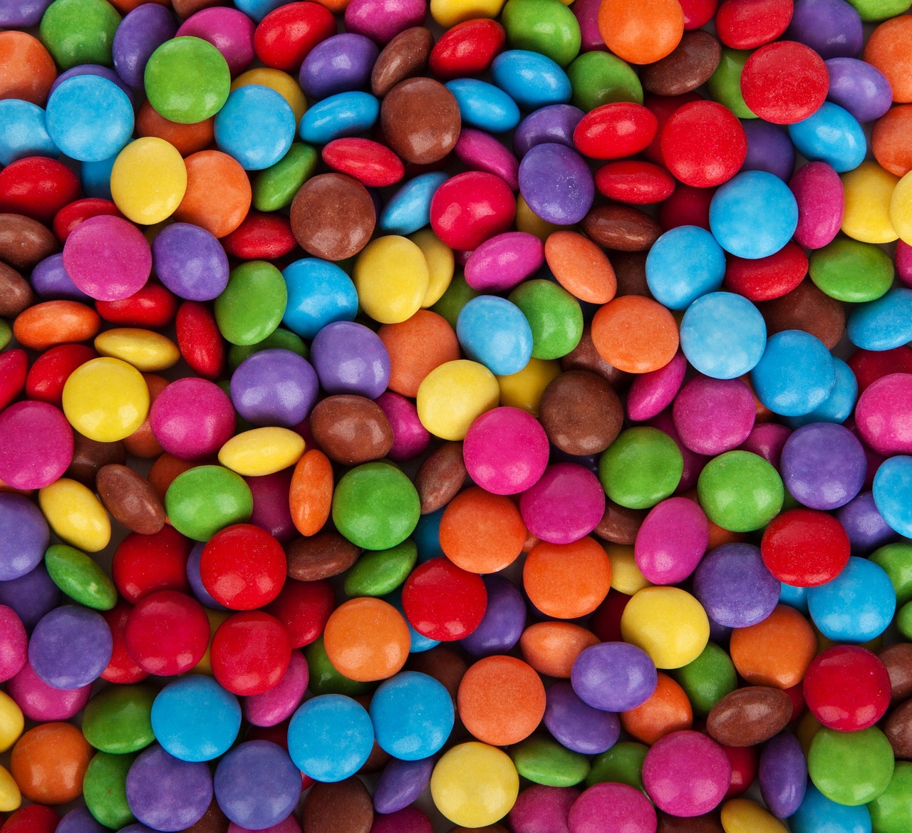 a pile of multicolored candy sitting on top of a table, color field, fully chocolate, colorful ben day dots, grain”, high quality product image”
