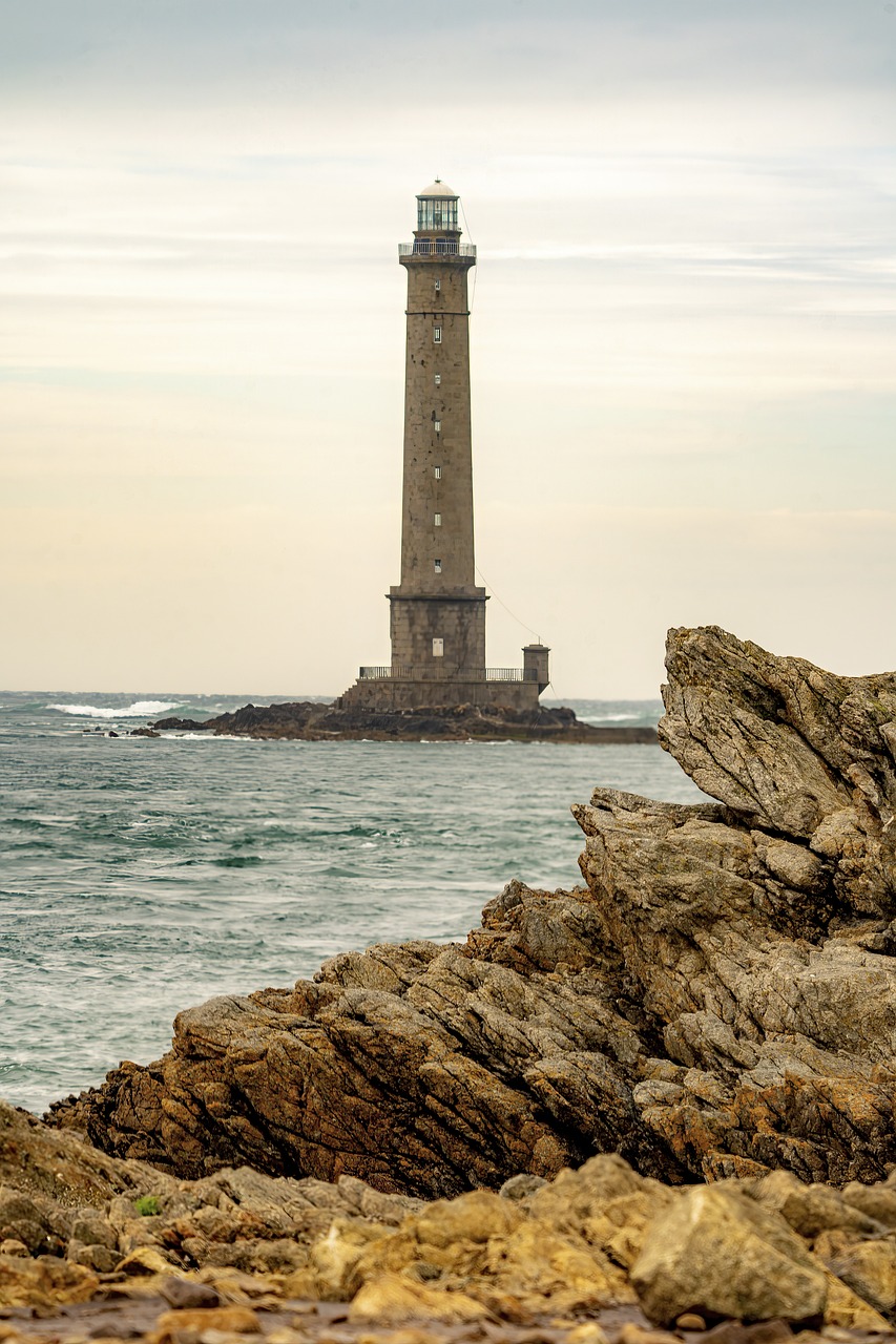 a lighthouse sitting on top of a rocky beach, a picture, by Cedric Peyravernay, shutterstock, les nabis, seen from a distance, pillar, panorama, 7 0 mm photo