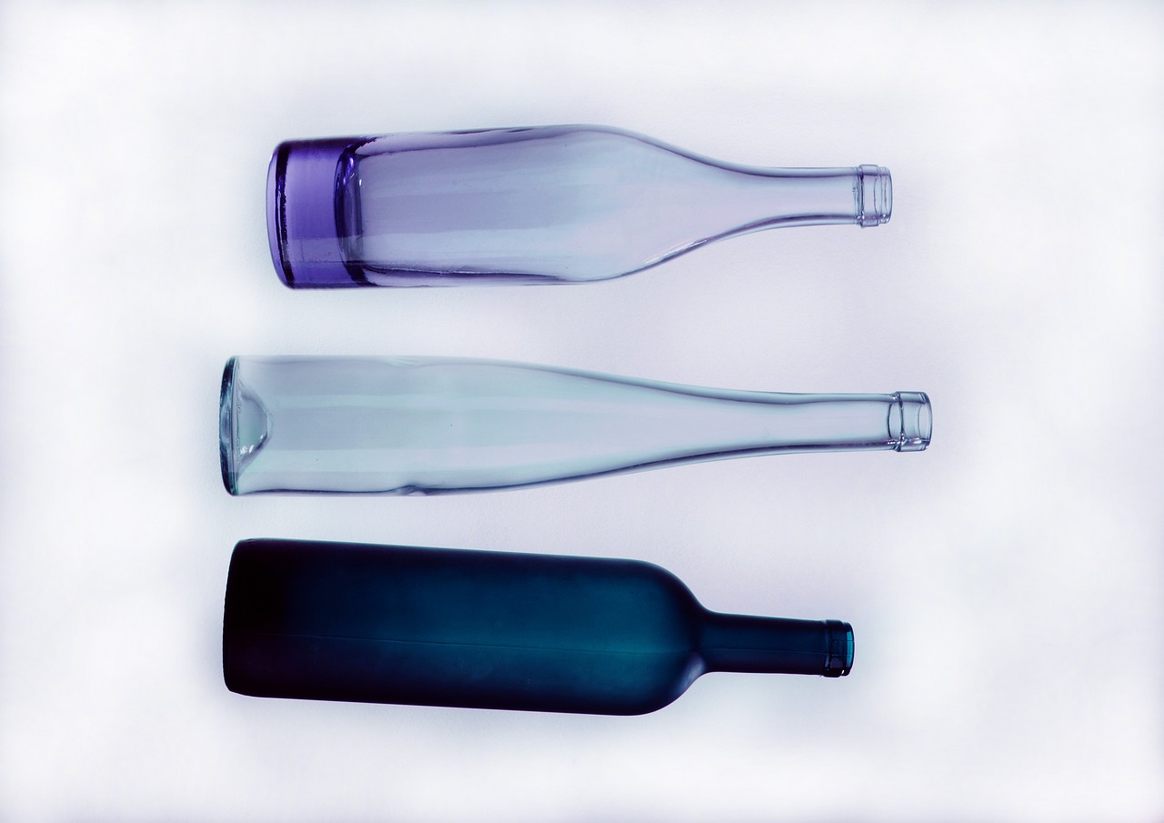 three empty glass bottles sitting next to each other, by Jan Rustem, minimalism, violet colors, various styles, top down shot, detailed product photo