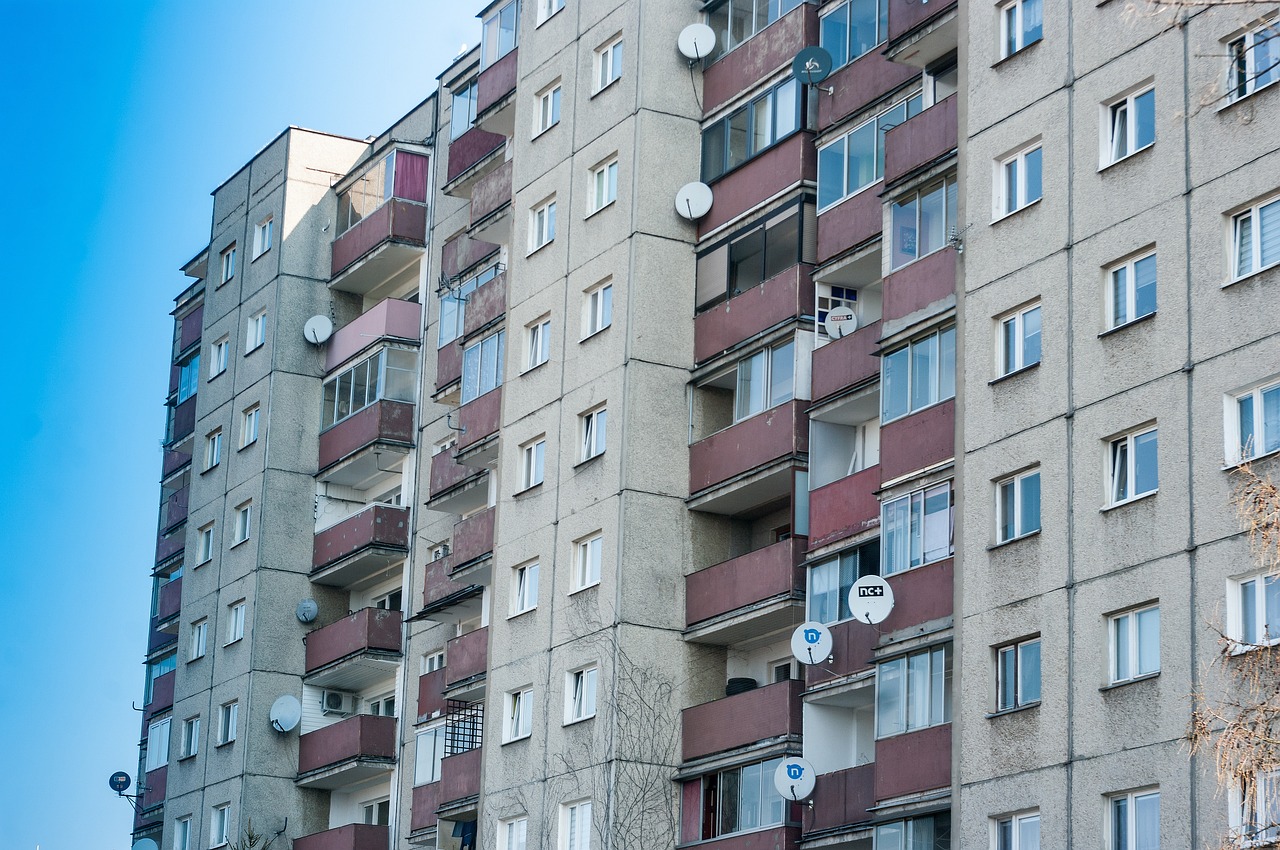 a very tall building with lots of windows, a photo, by Gabor Szikszai, shutterstock, soviet suburbs, hungarian, cheap, cracks