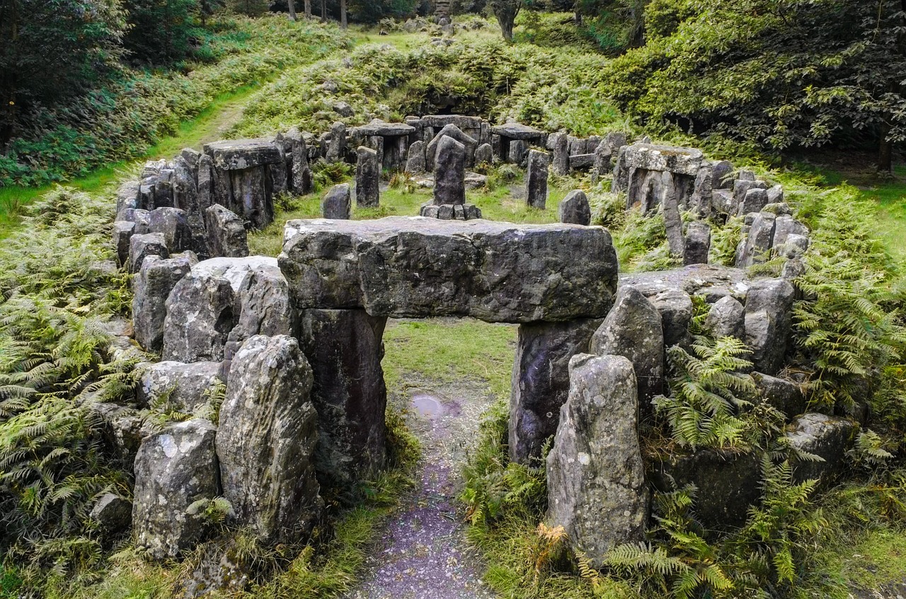 a stone circle in the middle of a forest, in an ancient altar, there is a place in wales, symmetrical long head, inside her temple