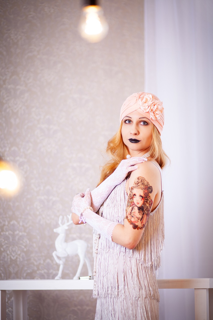 a woman with a tattoo on her arm, a portrait, inspired by George barbier, shutterstock, beautiful girl in an empty room, portrait of albino mystic, 1 9 2 0 s cloth style, photo taken with nikon d 7 5 0