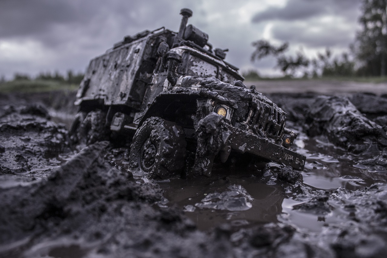 a military vehicle is stuck in the mud, a portrait, shutterstock, photorealism, highly detailed toy, shot on leica sl2, overcast mood, molten