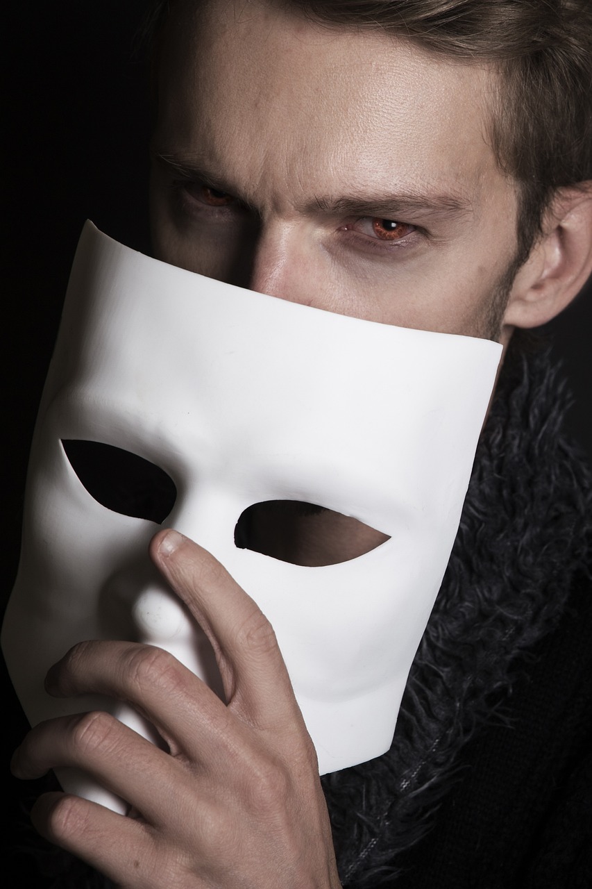 a man with a white mask covering his face, a photo, by Edward Corbett, shutterstock, romanticism, dangerous mephisto from faust, left profile, advertising photo, mid shot photo