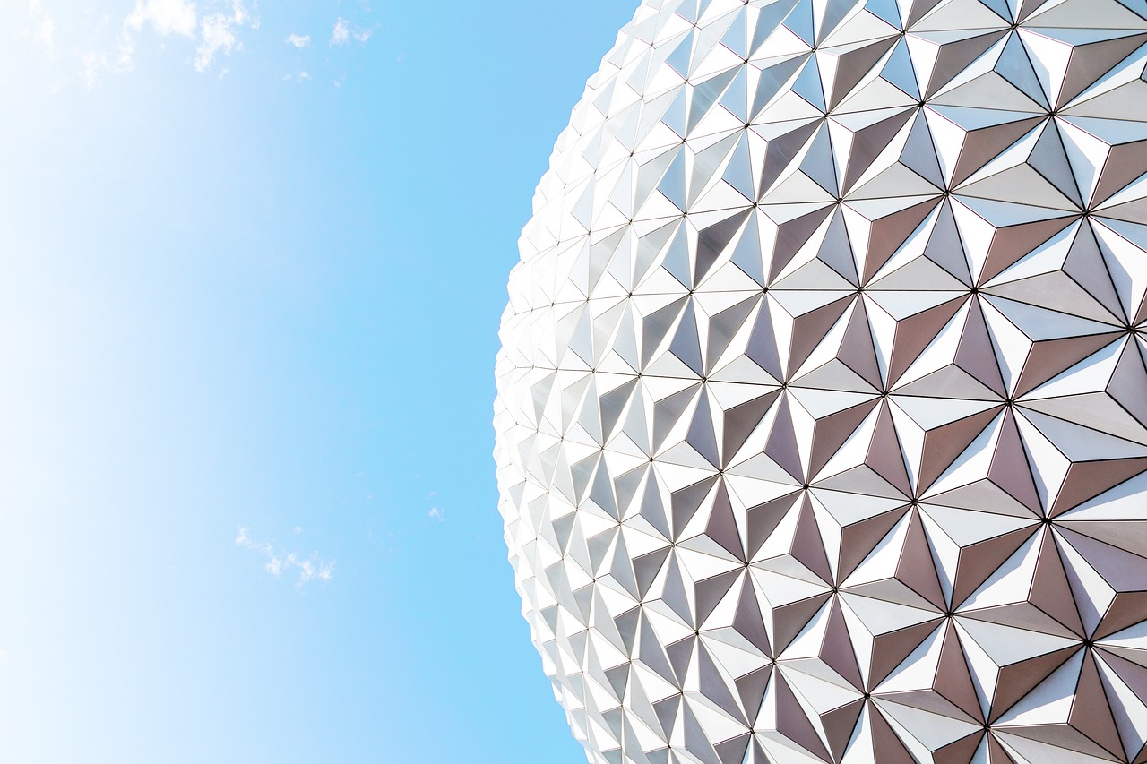 a close up of a building with a sky background, inspired by Buckminster Fuller, shutterstock, disney world, detailed white, epcot, spherical