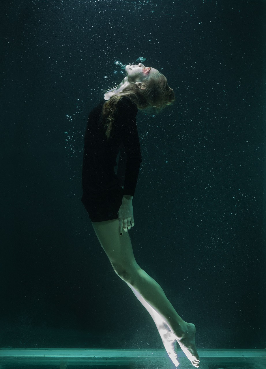 a woman in a black shirt is under water, inspired by Elsa Bleda, in style of britt marling, zero gravity, adult swim, britt marling style