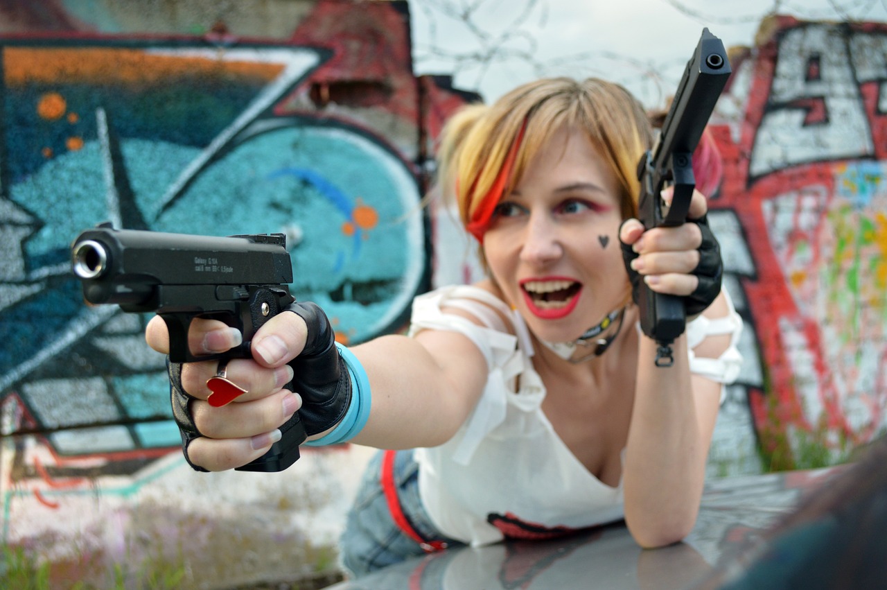 a woman pointing a gun at the camera, a portrait, deviantart, graffiti, cosplay photo, harley quinn film still, anime style”, chucky style
