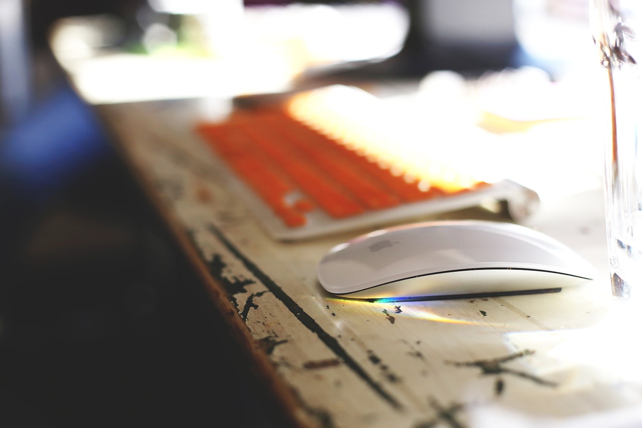 a computer mouse sitting on top of a wooden desk, a picture, pexels, bokeh photo, white and orange, high res photo, various posed