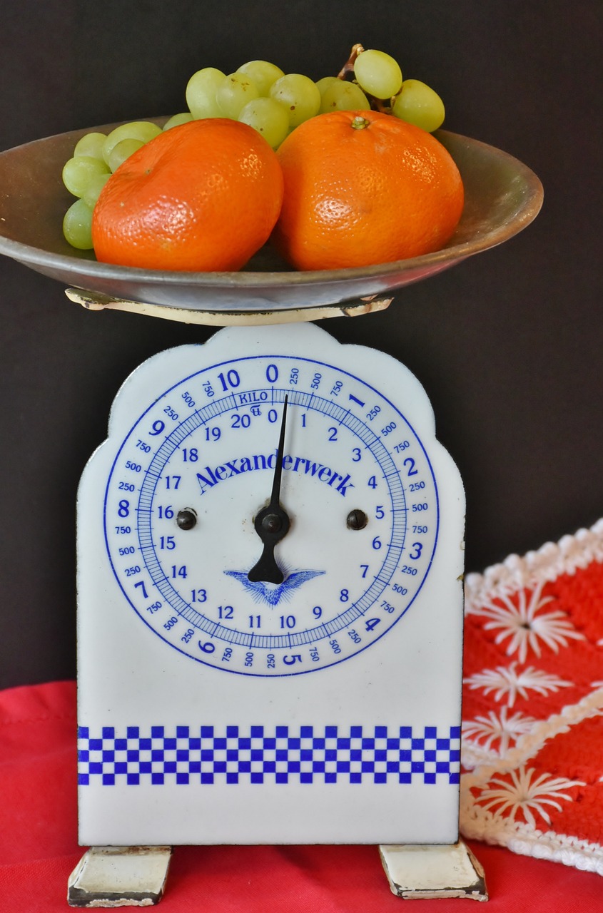a scale with a bowl of fruit on top of it, flickr, folk art, orange and white, closeup photo, ultramarine, 1940s photo