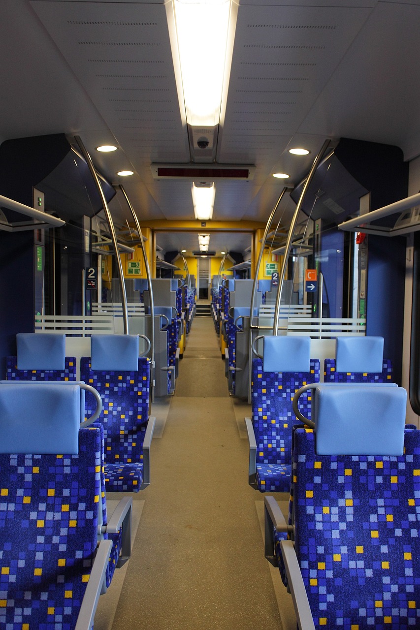 the inside of a train with blue seats, by Karl Völker, flickr, yellow scheme, street tram, slightly pixelated, the photo shows a large