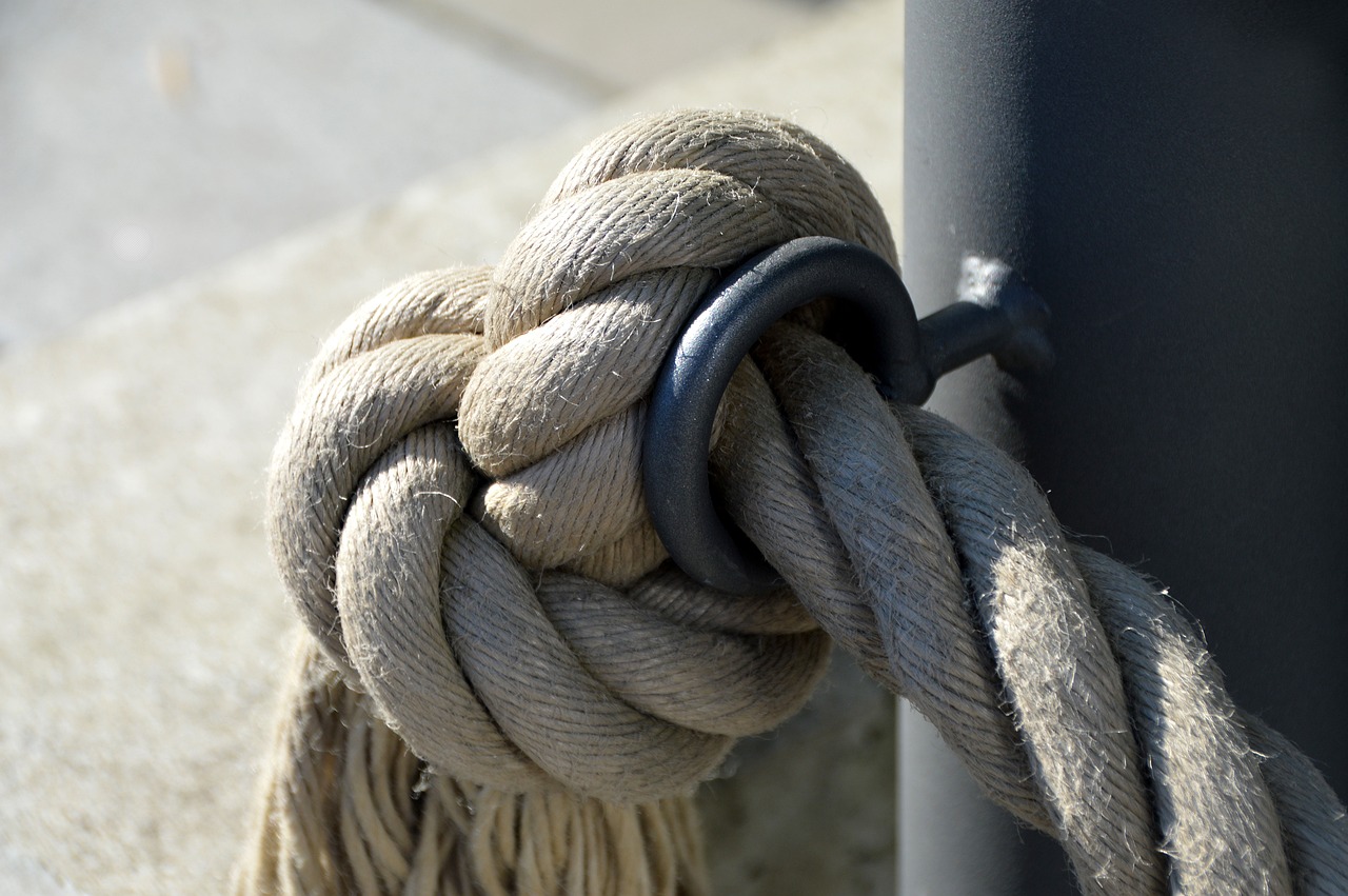 a close up of a rope on a pole, by Edward Corbett, flickr, hook as ring, linen, high quality detailed, photo 50mm