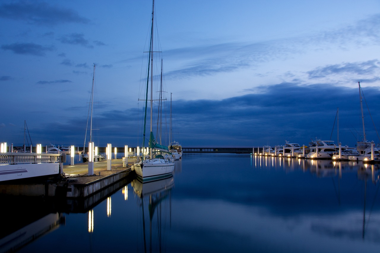 a number of boats in a body of water, a portrait, by Karl Hagedorn, shutterstock, peaceful evening harbor, blue night, shot with sigma f / 4. 2, sailboat