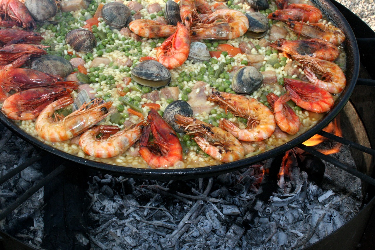 a close up of a pan of food on a grill, by Matteo Pérez, hurufiyya, costa blanca, festivals, rice, krakens