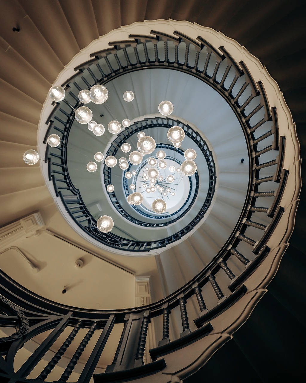 a spiral staircase in a building with lots of lights, pexels, light and space, orrery, neoclassical architecture, alvar aalto, 🦑 design