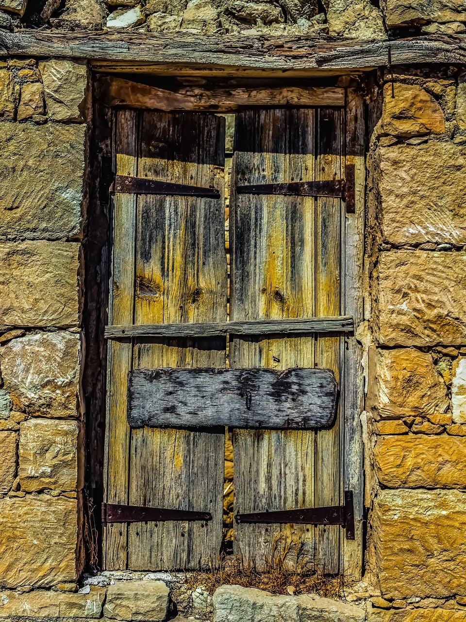 a close up of a wooden door on a stone building, by Richard Carline, on a yellow canva, intense dramatic hdr, shack close up, ned kelly