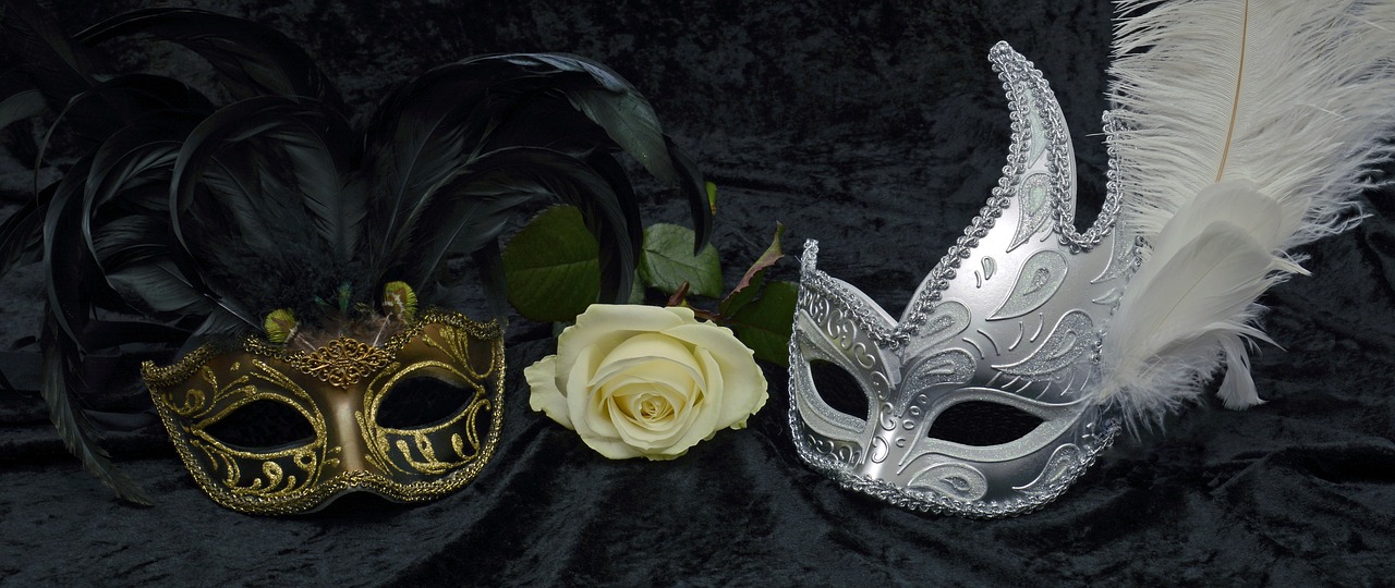 a couple of masks sitting next to each other, by Rhea Carmi, pixabay contest winner, baroque, she is the queen of black roses, silver white and gold, still life photo of a backdrop, wikimedia commons