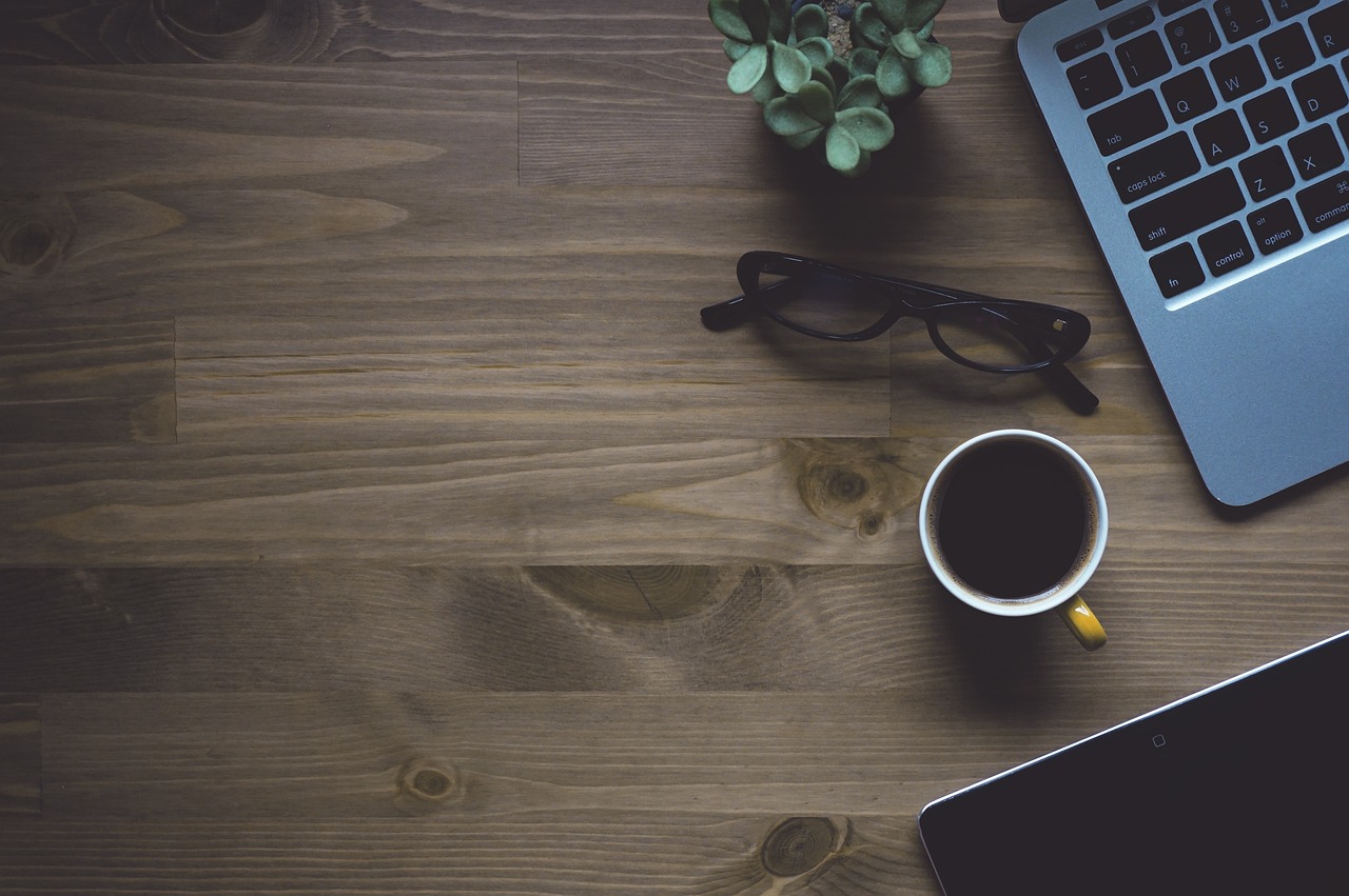 a laptop computer sitting on top of a wooden desk, pexels, is ((drinking a cup of tea)), stylized photo, topdown, wallpaper - 1 0 2 4