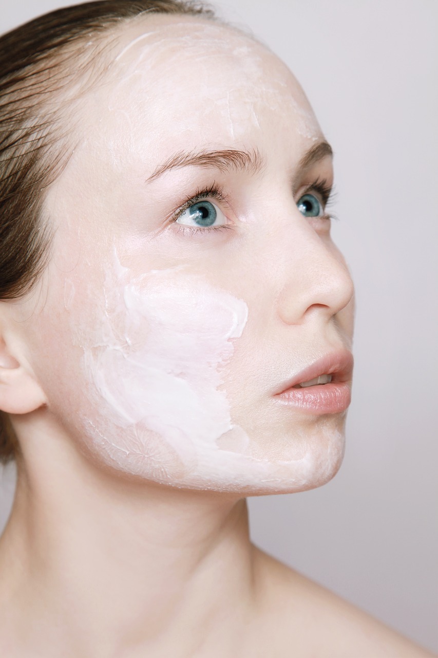 a woman with a lot of cream on her face, by karlkka, shutterstock, natural soft pale skin, young female face, detailed face with mask, close up portrait photo