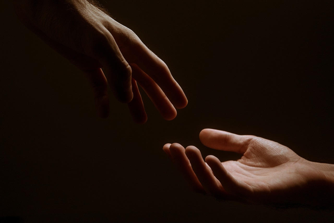 two hands reaching towards each other in a dark room, by Alexis Grimou, paul barson, benevolence, tenderness, giving gifts to people